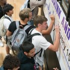 Students sign Every 15 Minutes pledge banner.